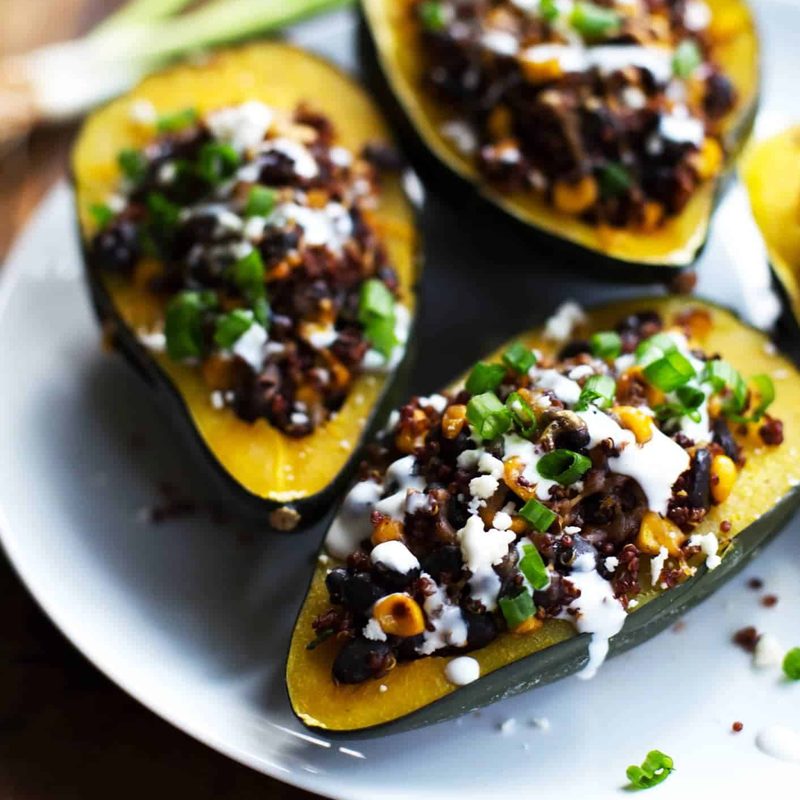 Mexican Roasted Corn and Quinoa Stuffed Squash: loaded with red quinoa, black beans, roasted corn, and cheddar cheese. High protein, high fiber, and just 200 calories. | pinchofyum.com