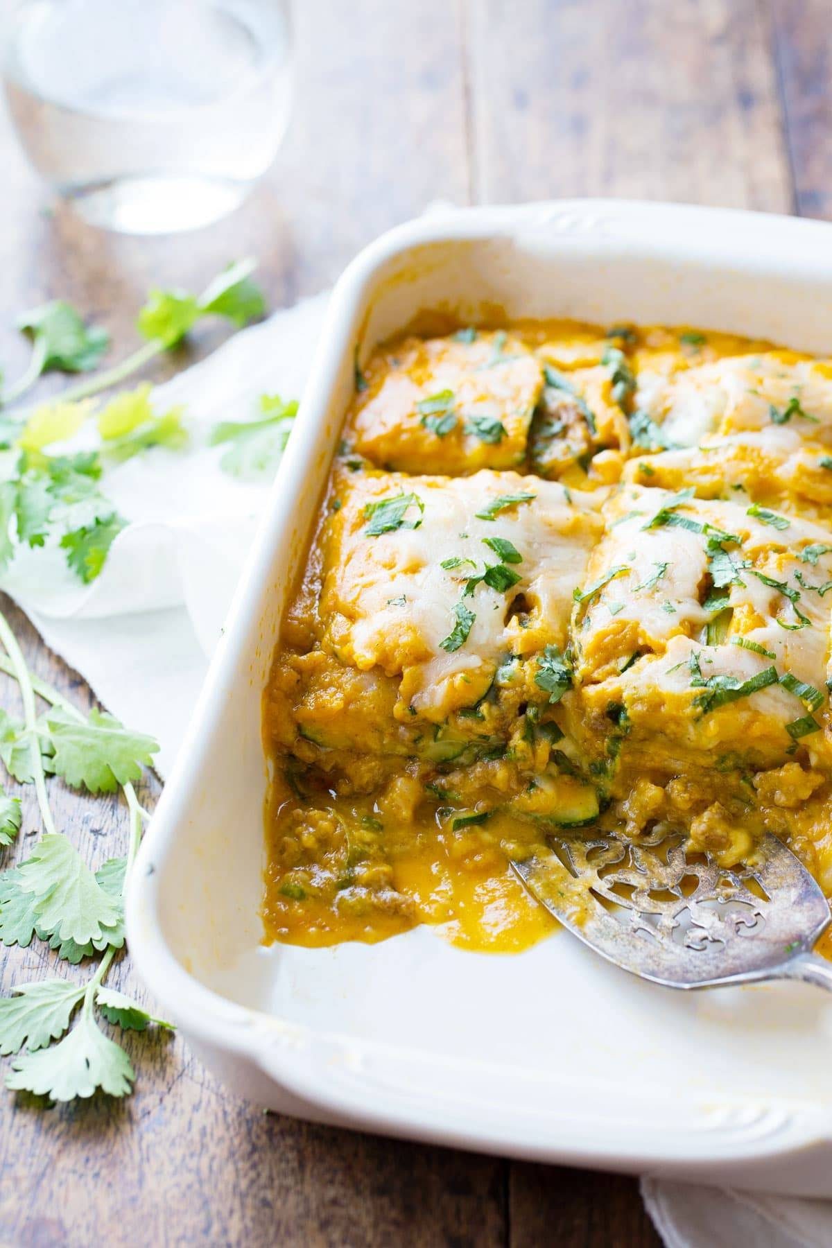Sausage and Sweet Potato Zucchini Lasagna in a white baking dish.