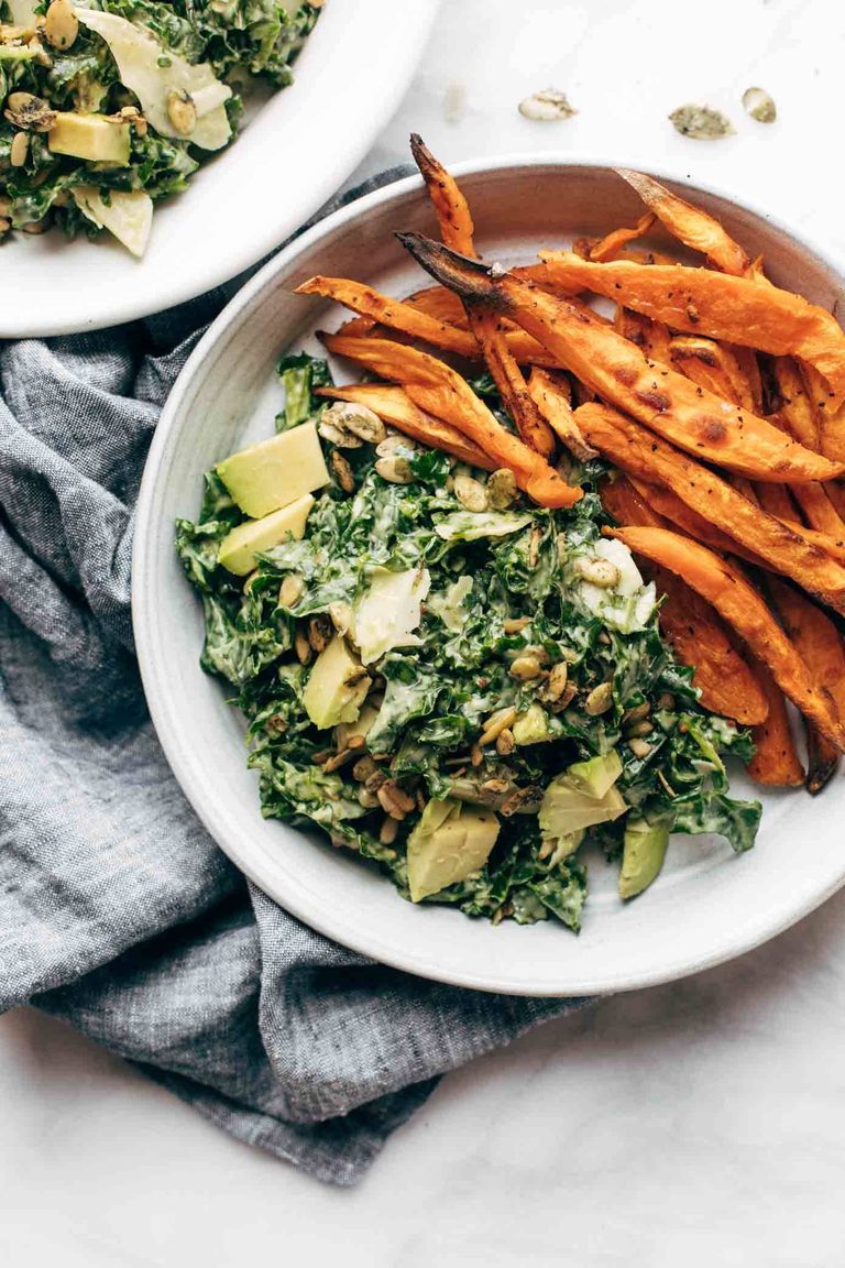 Avocado kale caesar salad with sweet potato fries.