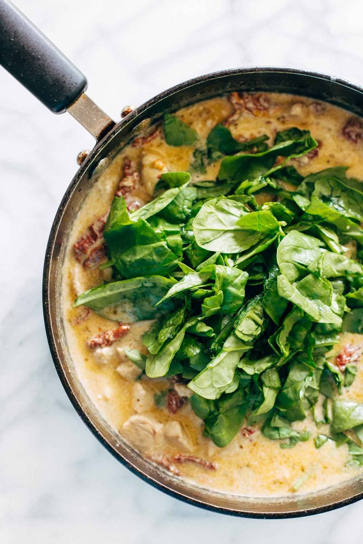 Sun Dried Tomato Chicken Florentine Pasta - a 30 minute recipe with a sun dried tomato cream sauce, chicken, ziti, and Mozzarella cheese. | pinchofyum.com