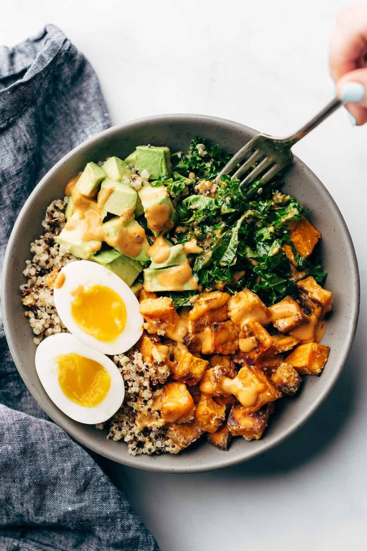 Sweet potatoes, kale, avocado, and eggs in a bowl.