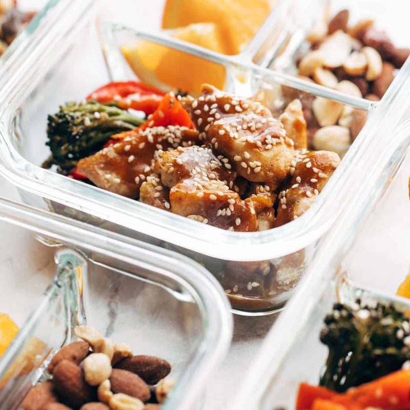 Sheet Pan Garlic Ginger Chicken and Broccoli in a clear container.