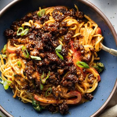 Peanut noodles topped with ground beef.