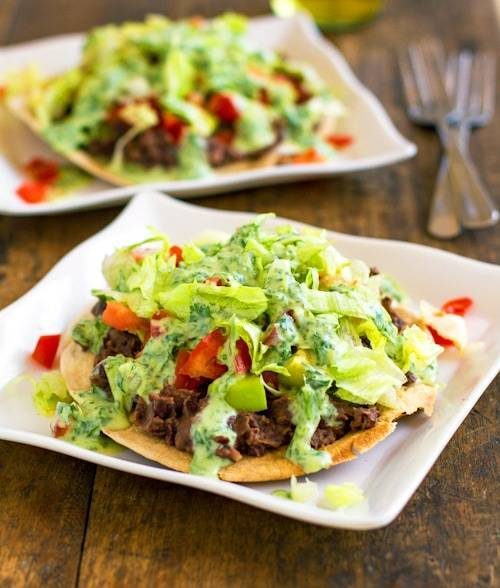 Black bean tostadas drizzled with a homemade healthy cilantro sauce.