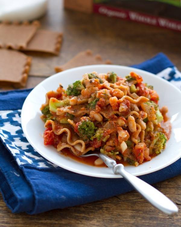 Broccoli and white bean lasagna on a plate with a fork.