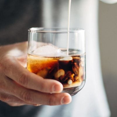 Cinnamon White Russian in a glass with cream.