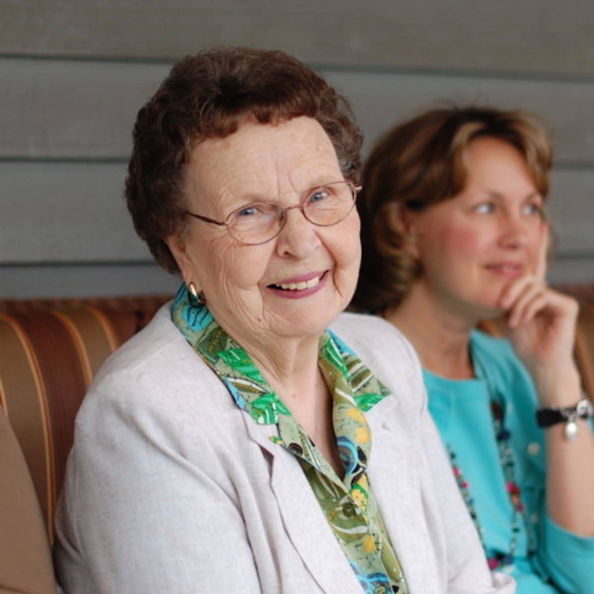 Elderly woman smiling at the camera.