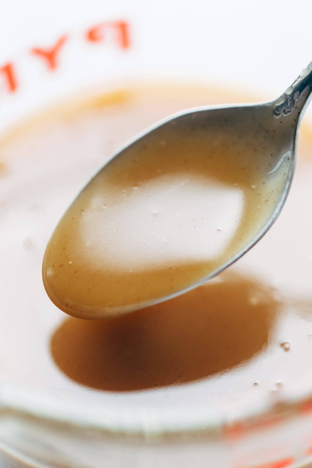 Strawberry Oat Crumble Bars syrup on a spoon